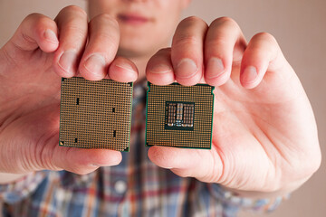 Hand holding cpu modules to assemble a computer, choosing the right components for a computer, types of central processor unit isolated