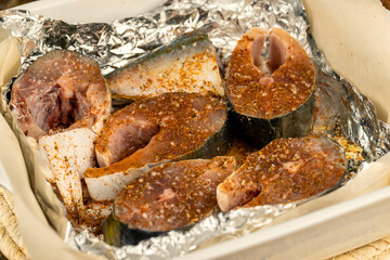 raw yellow-tailed fish during cutting for cooking