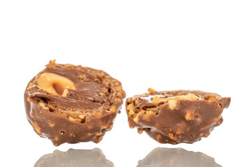 Two halves of a chocolate candy with a nut, macro, isolated on a white background.