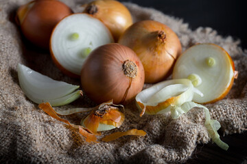Raw onions, in a composition on an old background