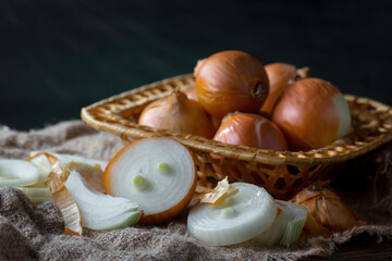 Raw onions, in a composition on an old background