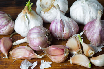 Garlic on a black background in the kitchen - a spicy vegetable