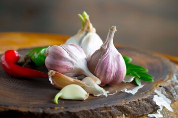 Garlic on a black background in the kitchen - a spicy vegetable