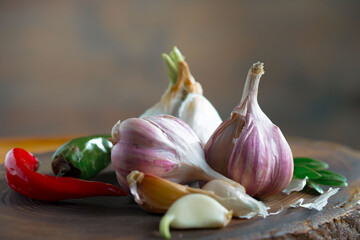 Garlic on a black background in the kitchen - a spicy vegetable