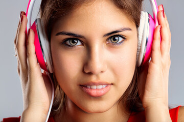 Enjoying melodies, she wears vibrant headphones