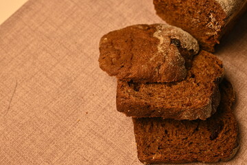 Sliced black bread on a grey background, loaf of black borodish fresh bread, healthy bread 	