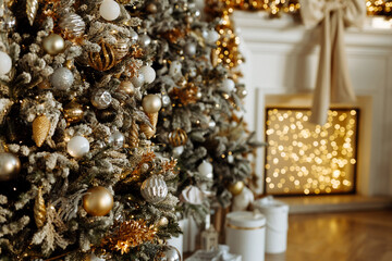 Beautifully decorated Christmas tree in close-up. There are blurred lights in the background
