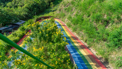 Image of the rainbow-colored ramp at the bottom of the cable car. In the part that is the U-turn...