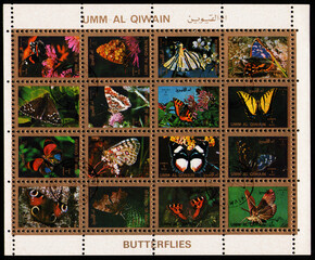 stamp set sheet printed in UMM-AL-QIWAIN (UAE) shows Different butterflies collection, circa 1972