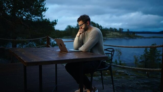 Young Adult Man Freelancer Working With Laptop In Night, Work Remotely In Trip