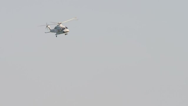 Helicopter flies in the blue sky at Kazan airport, long shot