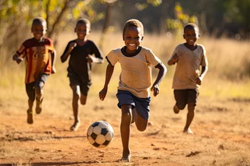 Fototapeten In the suburban neighborhood, a group of joyful friends, including a young African American boy, engage in a lively game of football. © sommersby