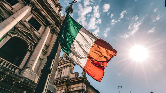 A stunning Italian tricolor national flag flutters in the wind on a pole with beautiful traditional Italian buildings in the background.	