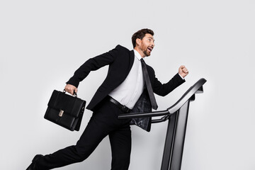 Profile photo of crazy classy person hand hold briefcase run treadmill empty space isolated on grey...