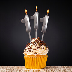 birthday cupcake with number 111 candle - Celebration on dark background