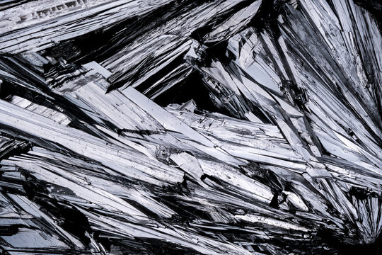 Stibinite macro photography detail texture background. close-up raw rough unpolished semi-precious gemstone
