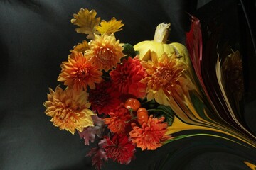 floral arrangement featuring fall colors and a pumpkin