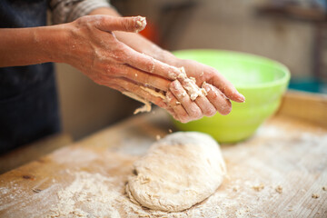 Adult Woman Cleaning Hands from Bread Dough after finish Crafting First Stage