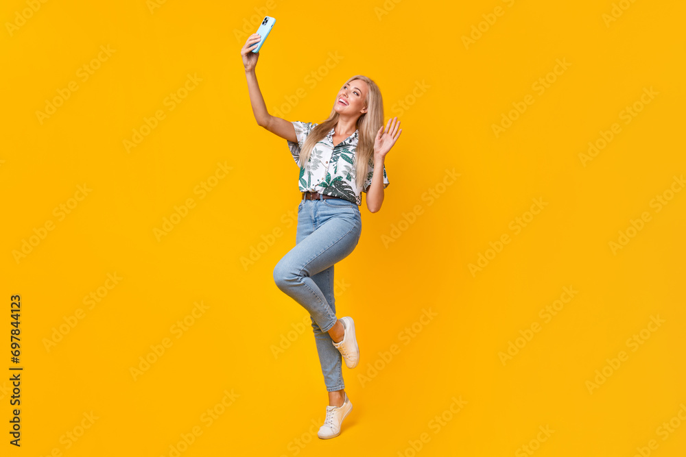 Sticker full size photo of adorable girl dressed print shirt jeans waving palm on smartphone doing selfie is