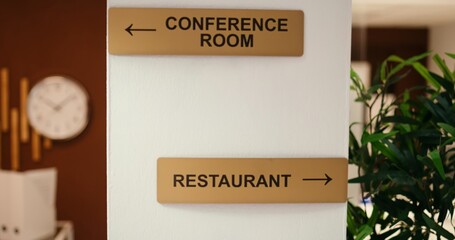 Close up jib shot of conference room, spa center and restaurant amenities signs in empty business...