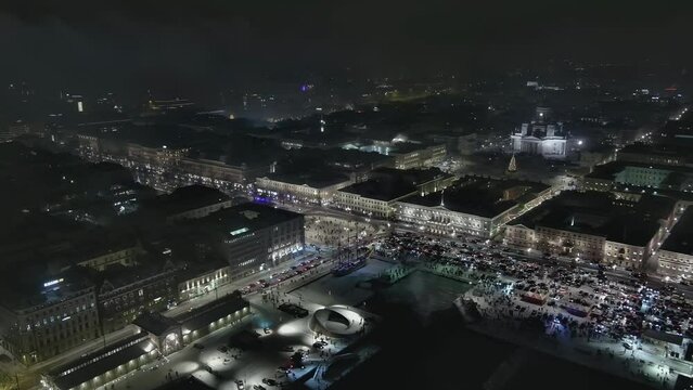 Helsinki.Finland-December 31.2021: Aerial shot of fireworks in the centre of Helsinki. Nighttime. Pretty cityscape. Wintertime. New years eve. Drone moving backwards and sideways.
