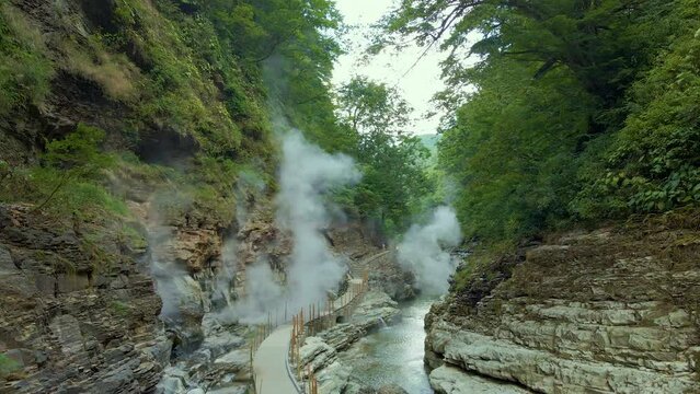 Cinematic aerial shot of steam vents at Oyasukyo Gorge in Akita prefecture in Japan