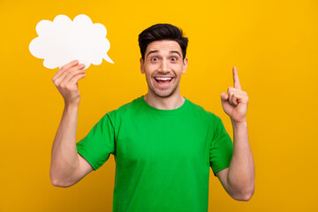 Photo portrait of attractive young brunet man hold paper cloud point up dressed stylish green...