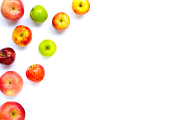 Variety of fresh apples on white background.
