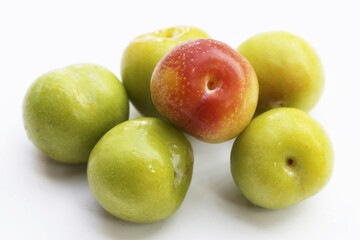 Fresh green plum on white background