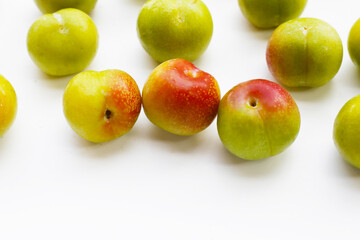 Fresh green plum on white background
