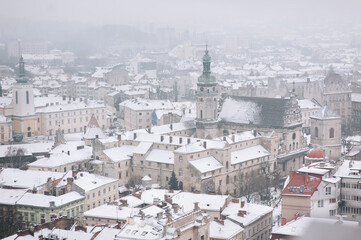 Winter snowy city, top view. Tower of St. Andrew's Church in Lviv, Ukraine.