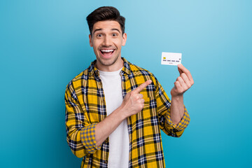 Photo of impressed excited man with bristle dressed plaid shirt indicating at credit card in arm...