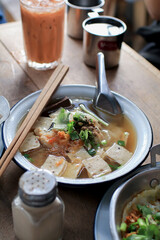 Vietnamese Rice Noodles Soup with vegetables and crispy onion in the white bowl. Vietnamese and Asian cuisine.