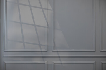 Shadow from window on grey wall indoors