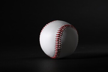 One leather baseball ball on black background