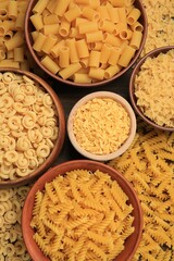 Different types of pasta on table, flat lay