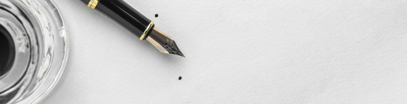 Fountain pen and inkwell on paper, top view. Banner design with space for text