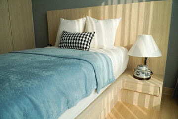 Double bed with pillows and lamp in modern bedroom, interior design,White empty wall, big window with curtains in bedroom interior