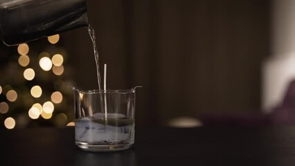 Pouring paraffin for candle in cozy home, close up view
