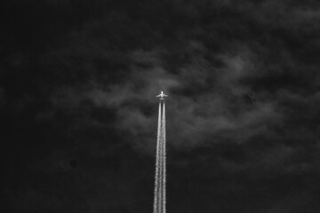 Airplane in the sky. Black and white photo of airplane.