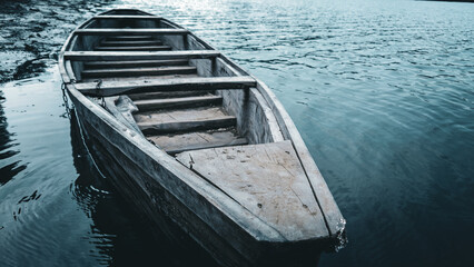 traditional old wooden boat on the river. close up vintage transportation in the lake