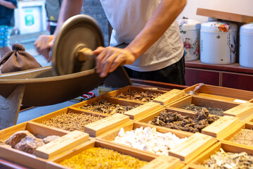On site grinding of traditional Chinese medicine in traditional Chinese medicine shops.. - obrazy, fototapety, plakaty