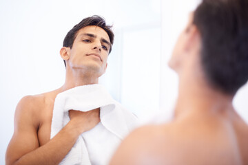Man, hygiene and towel after washing face in mirror, cleaning and skincare or beauty. Male person,...