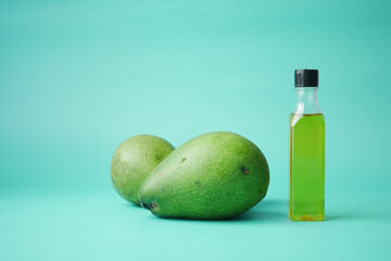 oil and slice of avocado on light green background  - Powered by Adobe