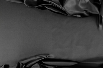 Black silk fabric textured background. Copy space
