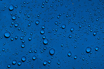 Water droplets on dark blue background