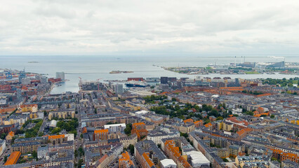 Fototapeta na wymiar Copenhagen, Denmark. Panorama of the city center and port in cloudy weather. Summer day, Aerial View