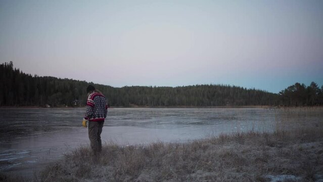 a Man Walks on a Frozen Lake - Static Shot