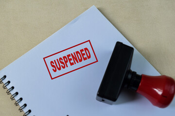 Red Handle Rubber Stamper and suspended text isolated on wooden background