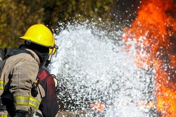 Structural Panoramic firefighters using Twirl water fog type fire extinguisher to fighting with the...